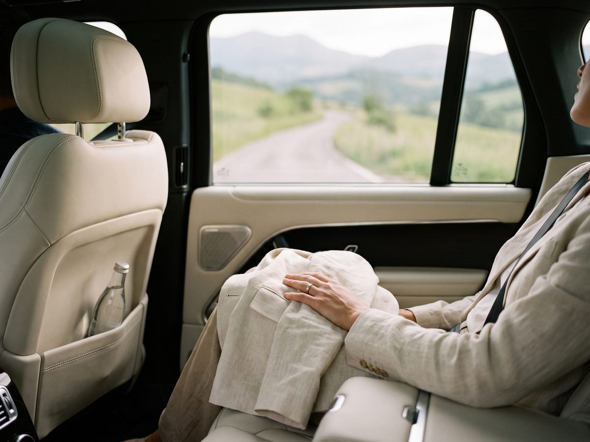 A calm car transfer through green hills.
